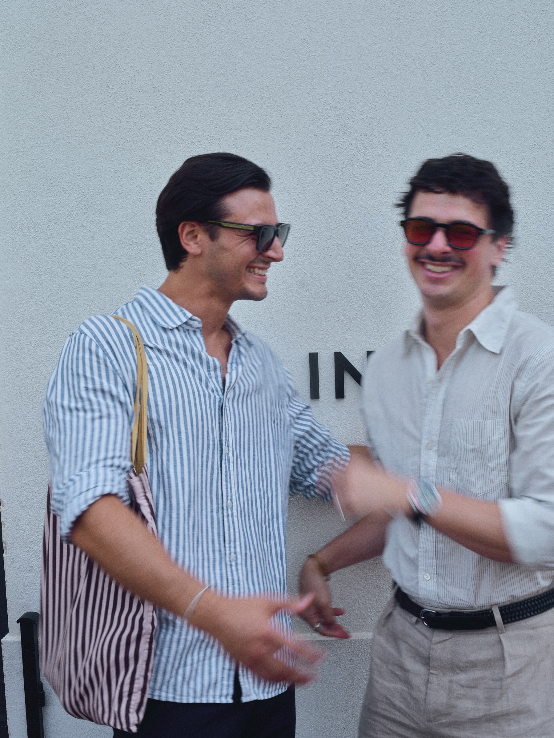 Two guests laughing together outside COLLINS House