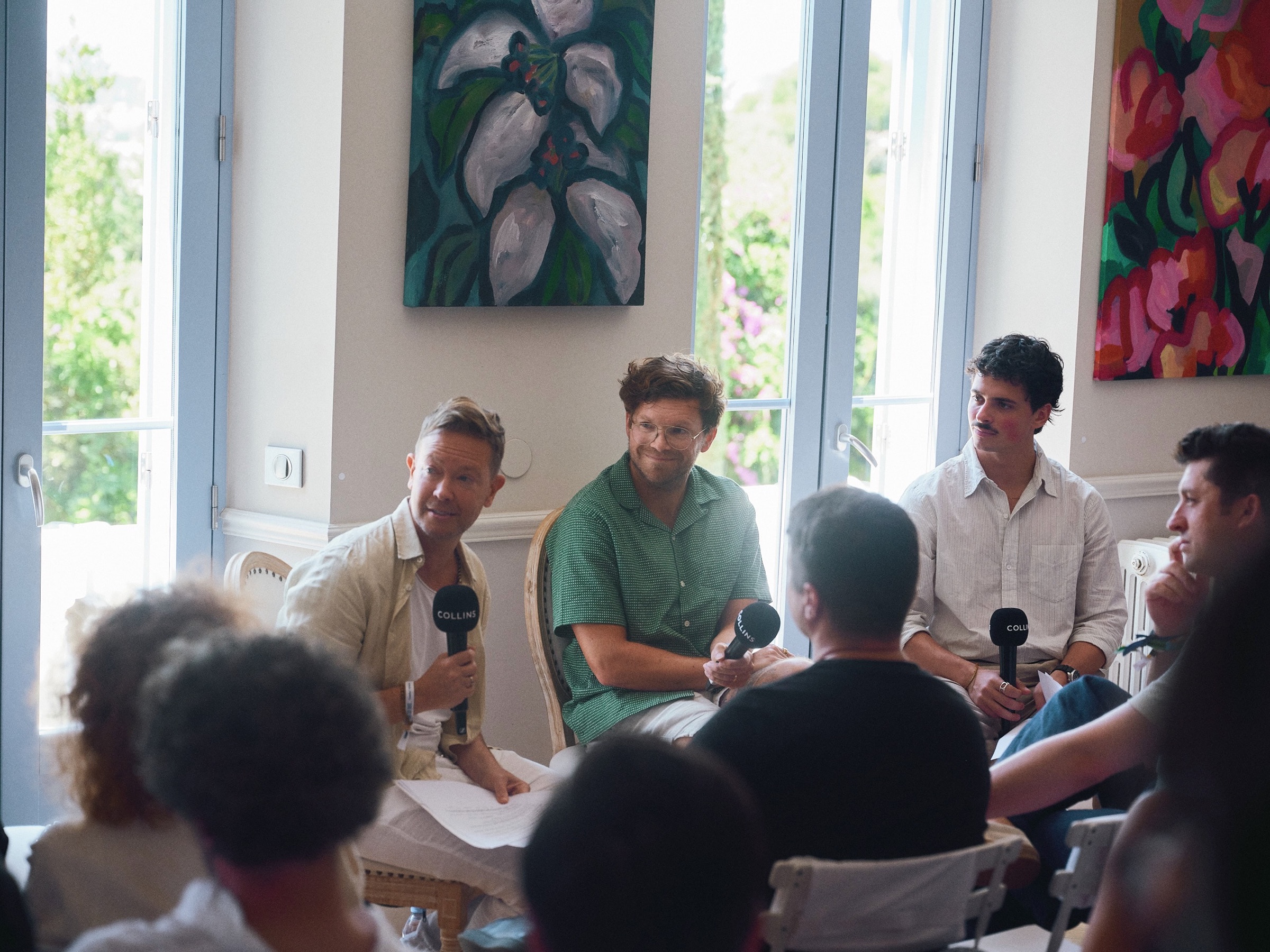 A conversation with speakers and guests inside COLLINS House
