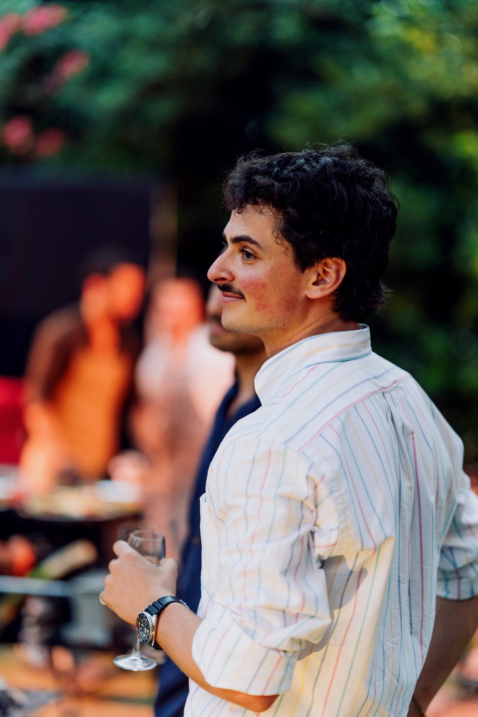 A guest at a garden gathering at COLLINS House