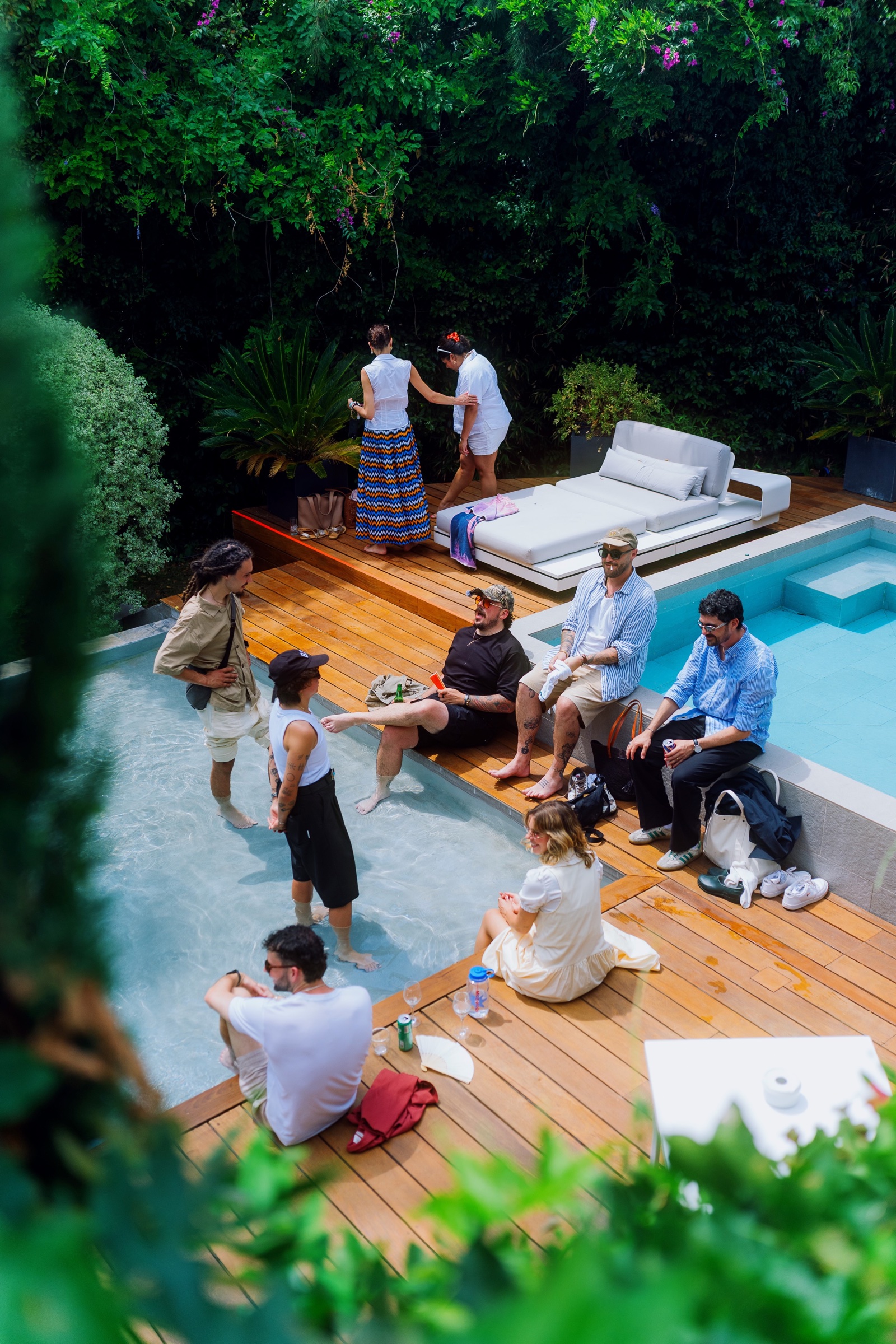 Guests talking beside the pool