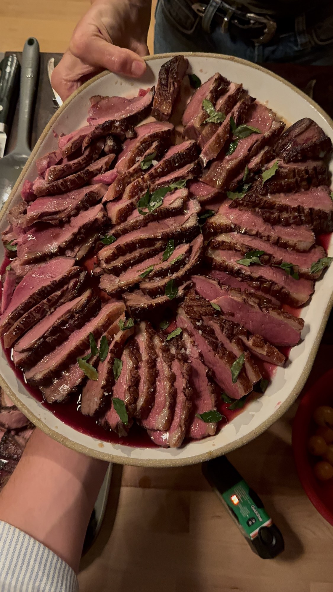 A platter of sliced duck brought to the table