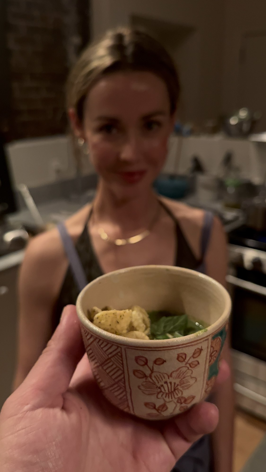 A guest with a cup of gazpacho at the Power dinner