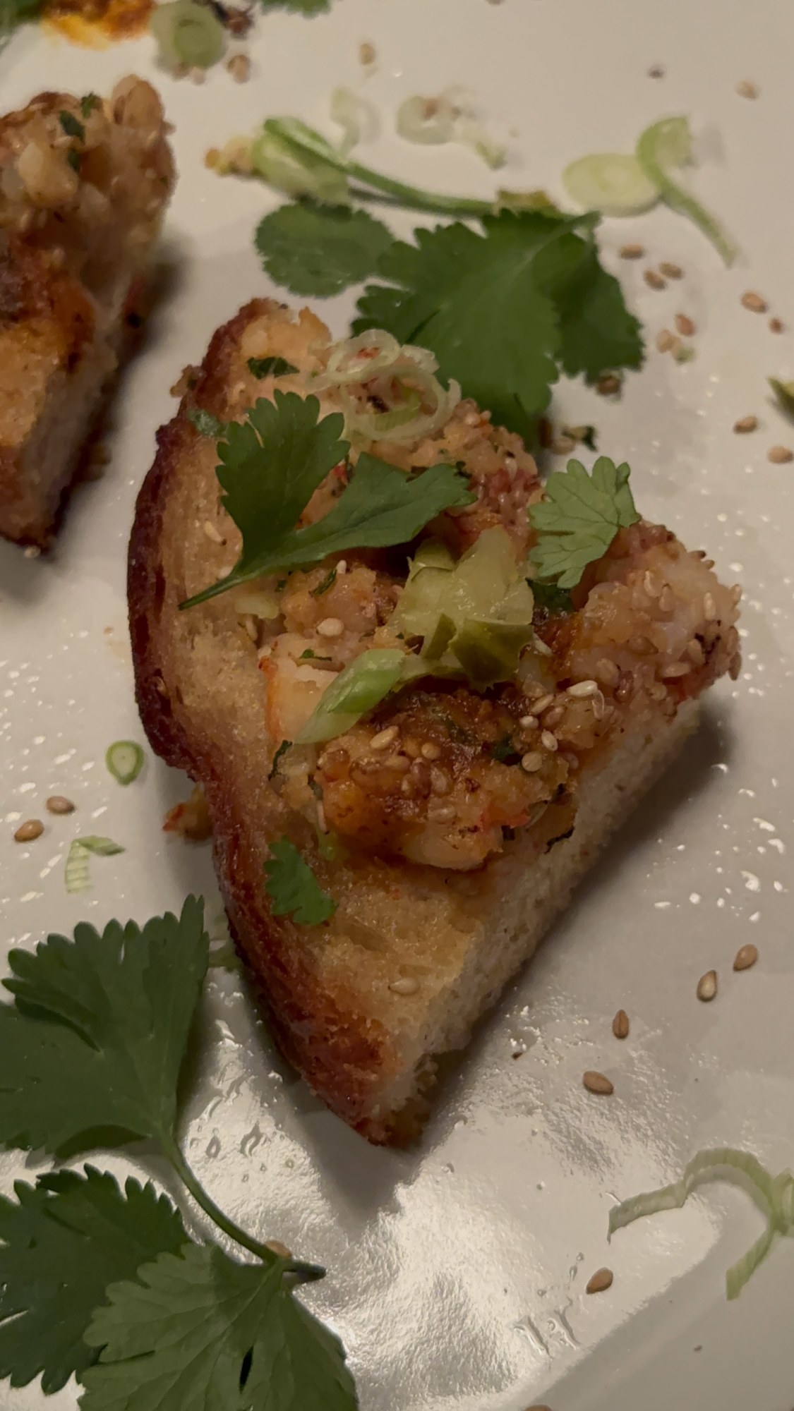 Shrimp toast topped with fresh herbs