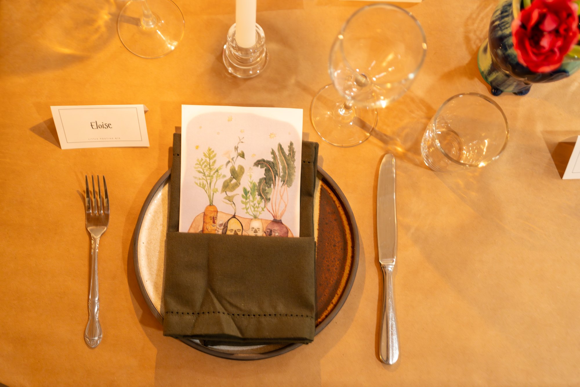 A place setting with flowers and a handwritten card