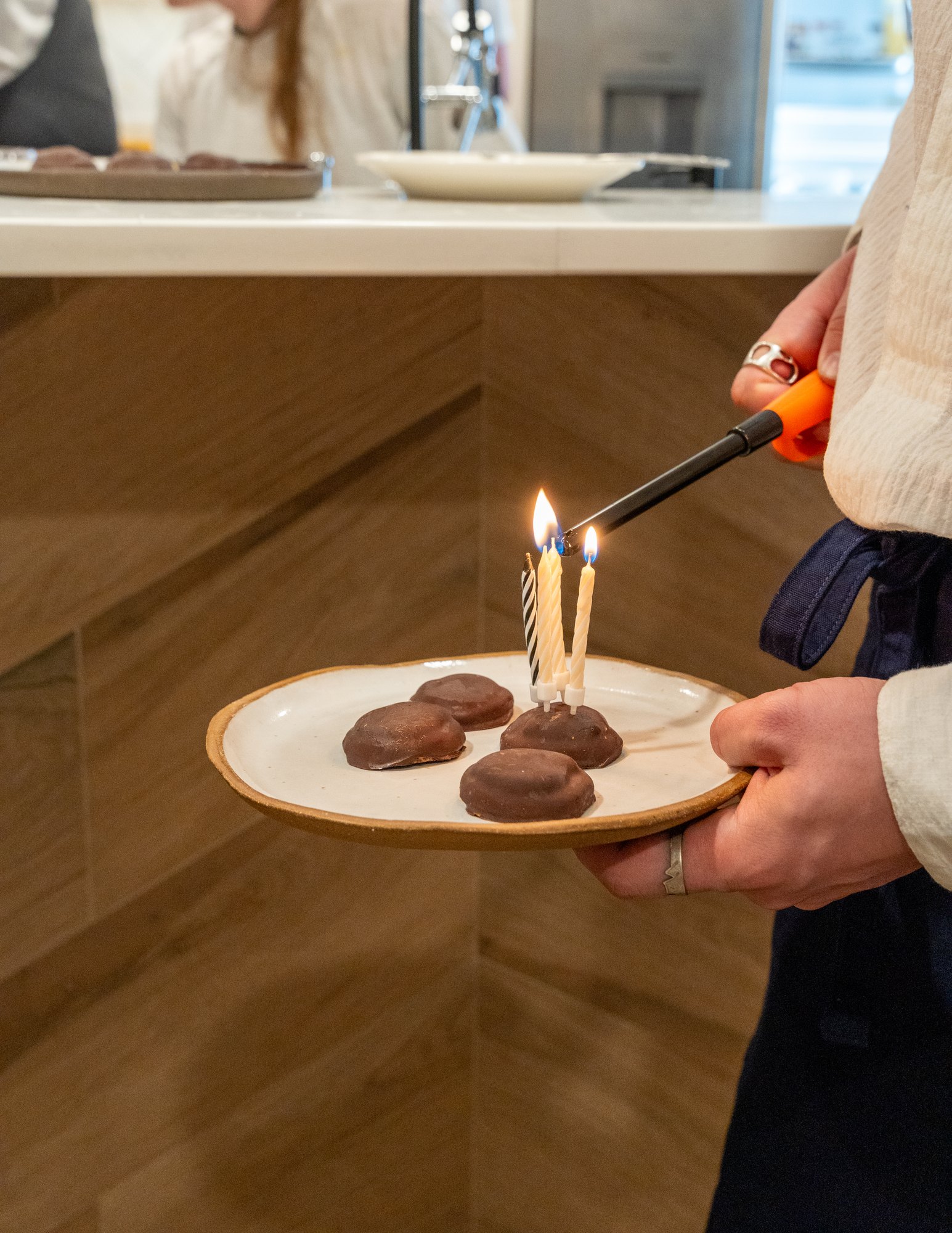 Lighting candles on a dessert plate