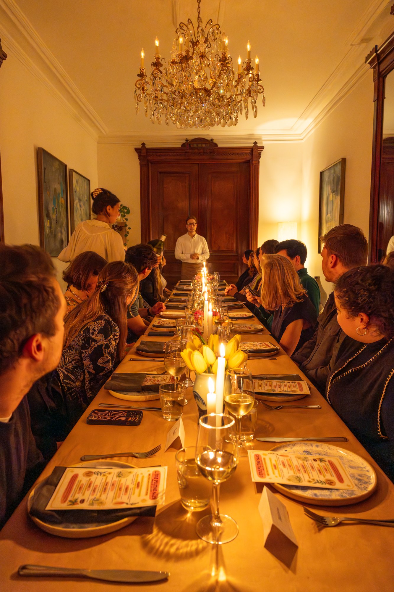 Guests gathered around a candlelit dinner table