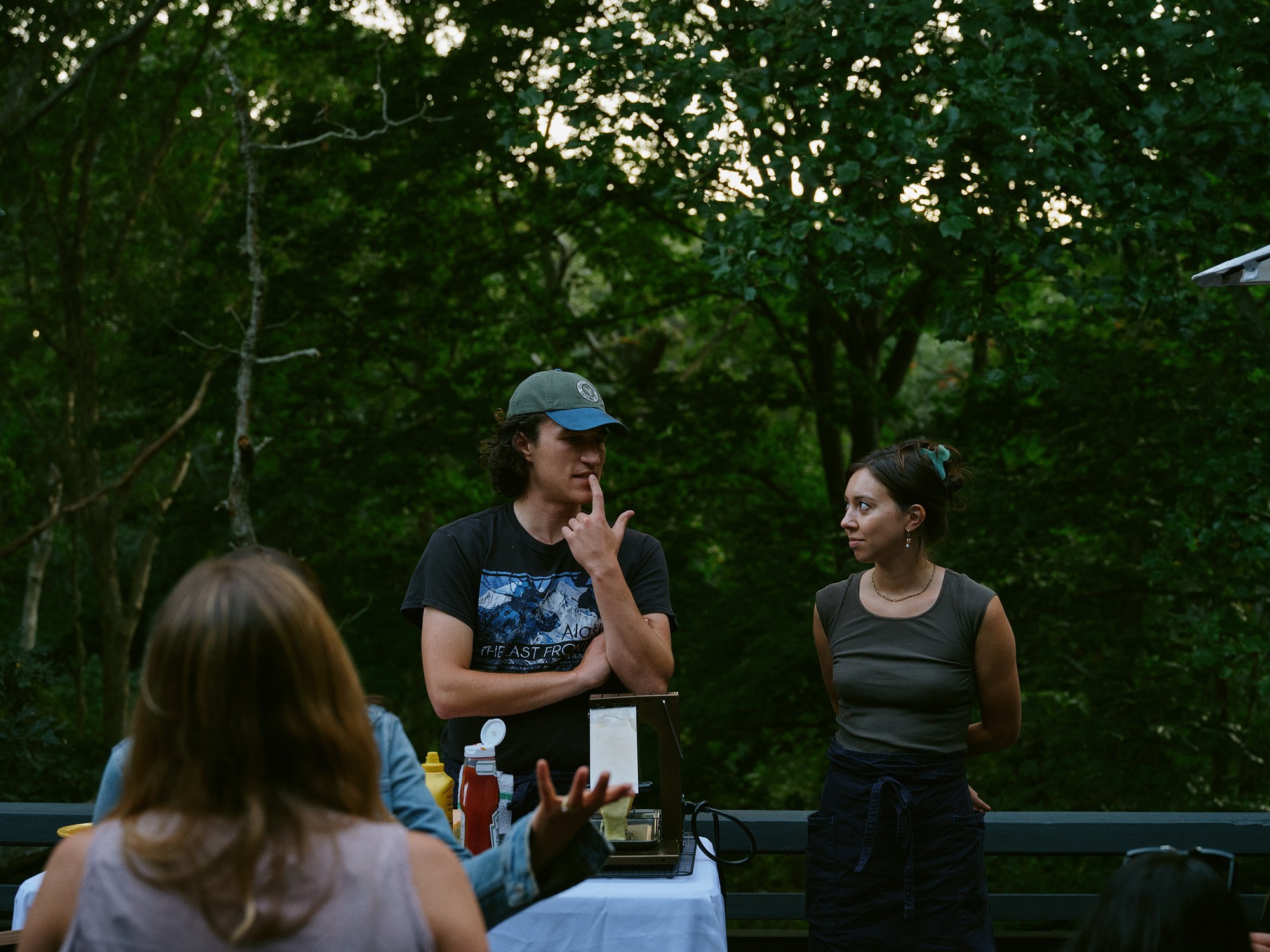 Guests in conversation beneath the trees