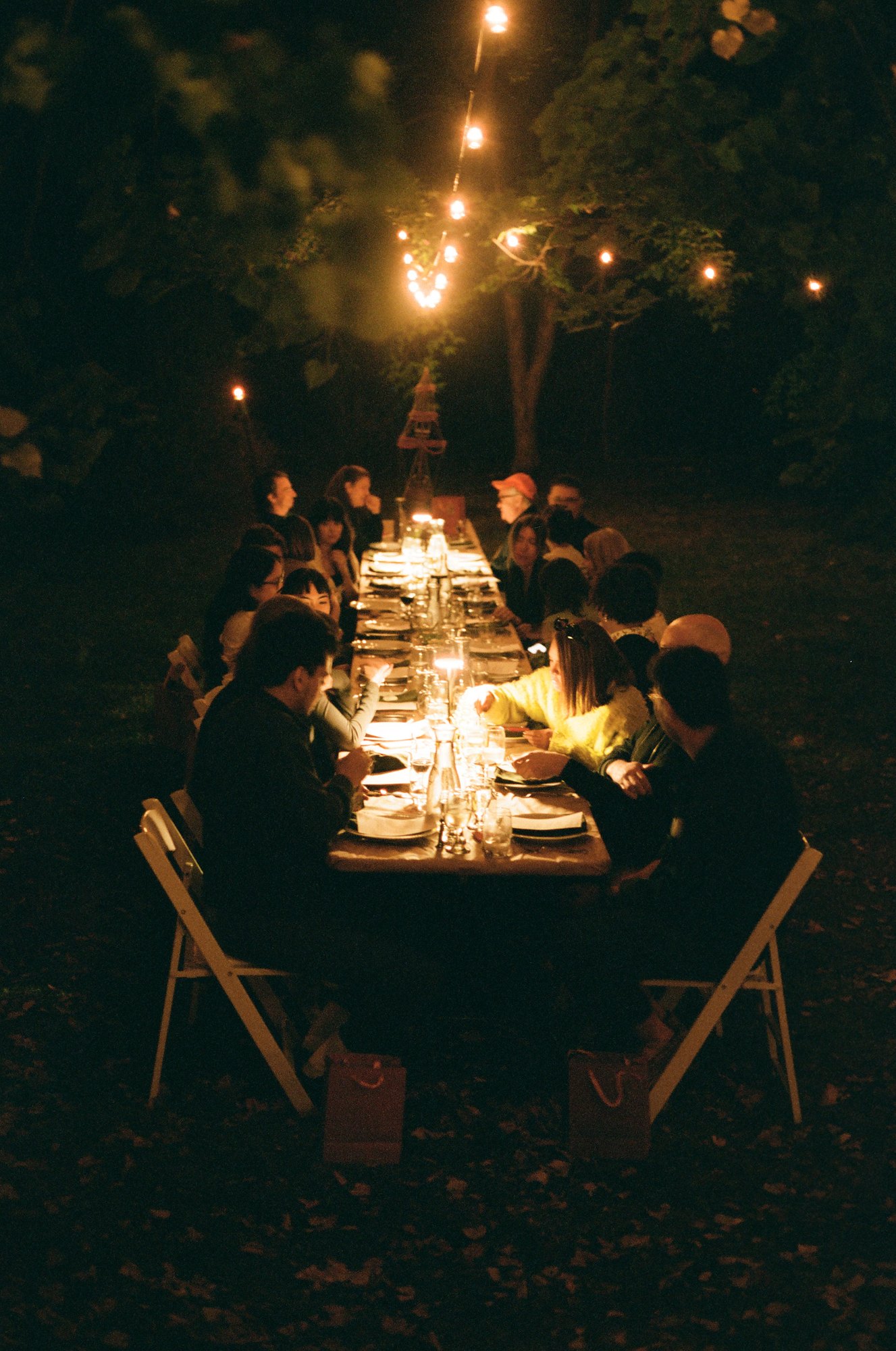 Candlelight along an outdoor dinner table