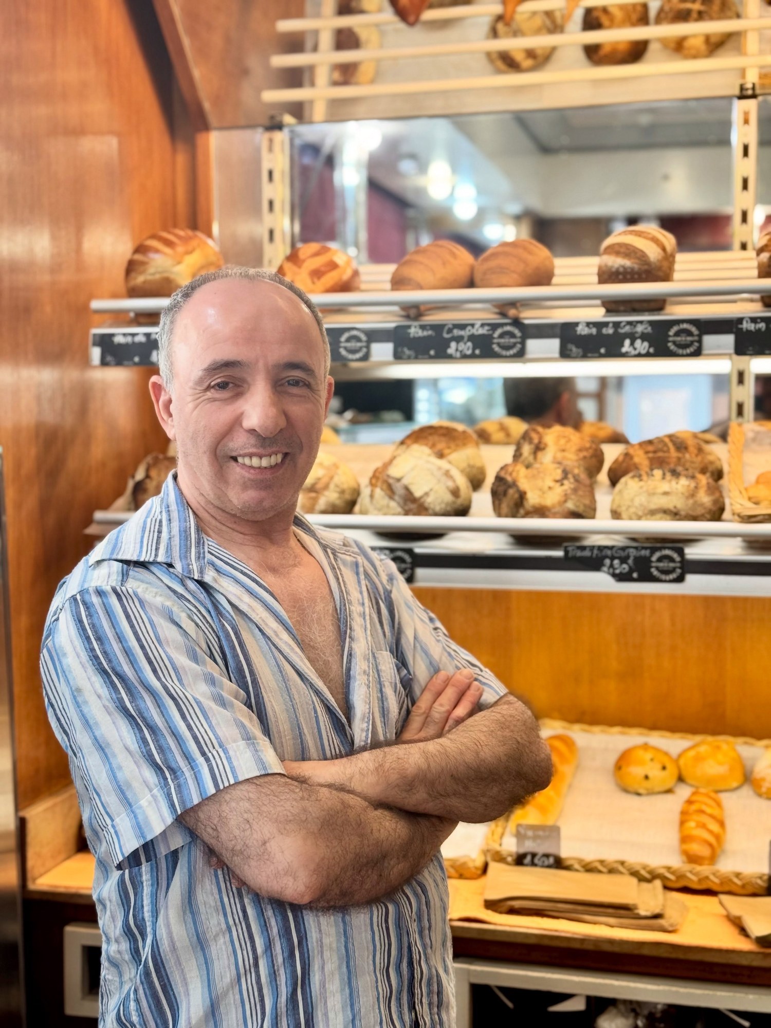 Bob in his Paris bakery, surrounded by fresh bread and pastries