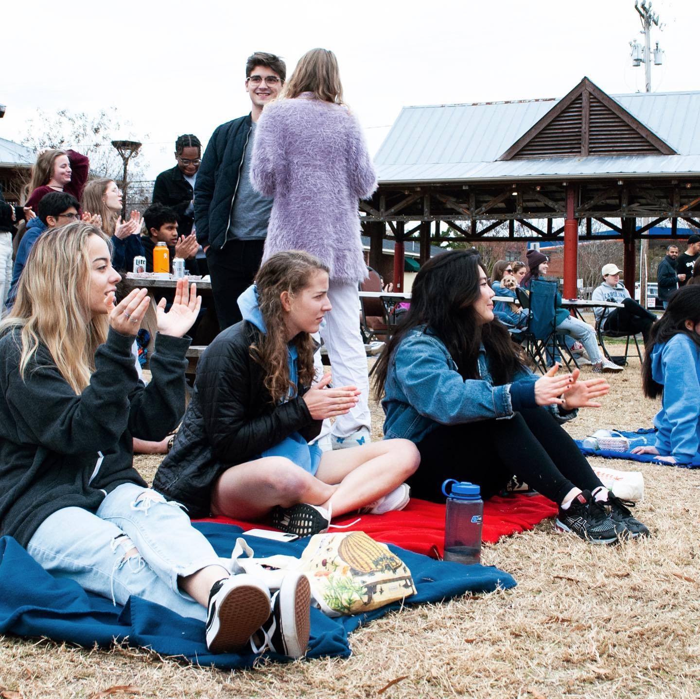 Festival guests sharing food on picnic blankets