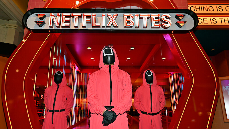 Three Squid Game guards outside the Netflix Bites entrance