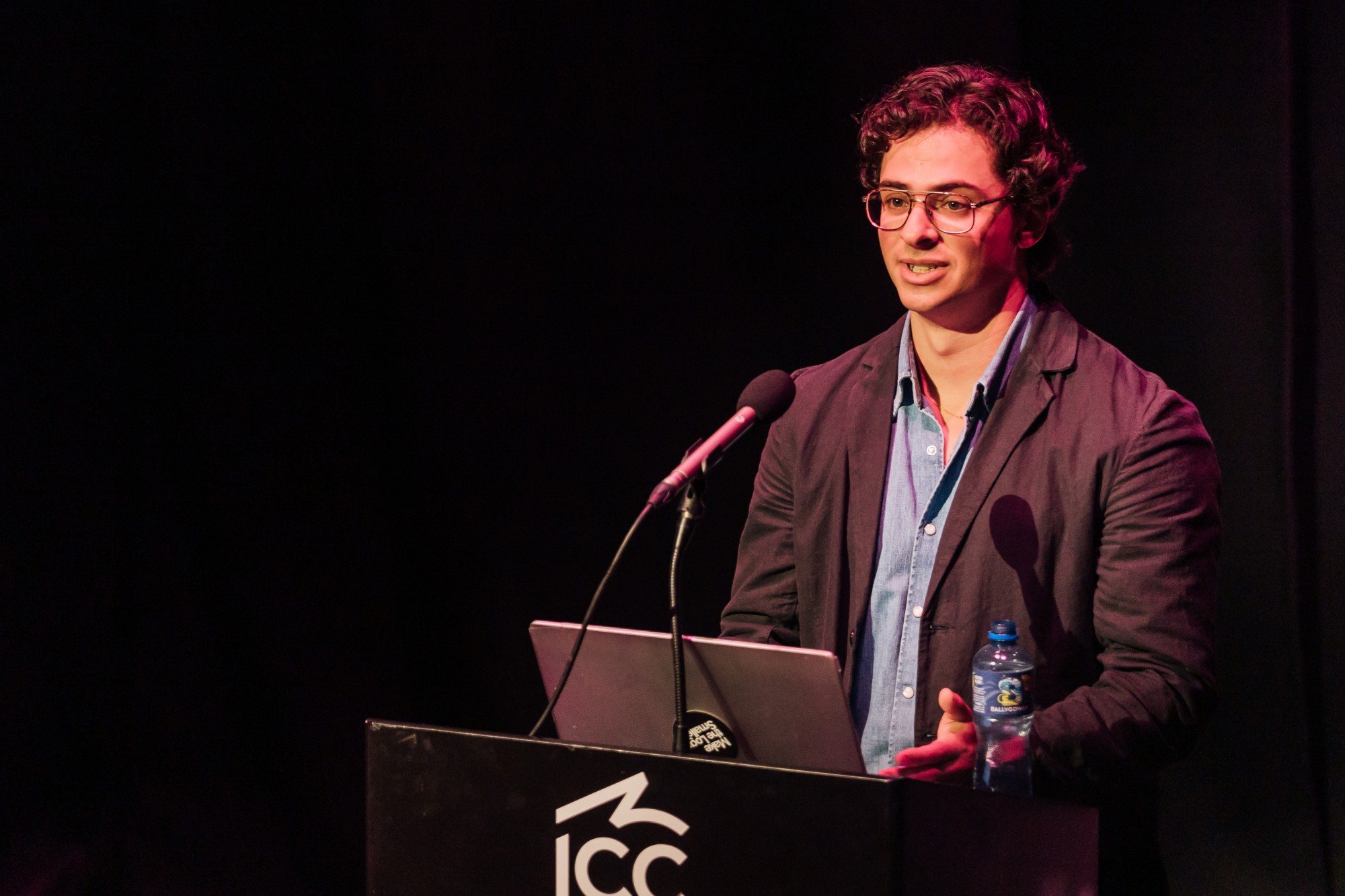 A close view of Eron speaking at the ICC Belfast podium