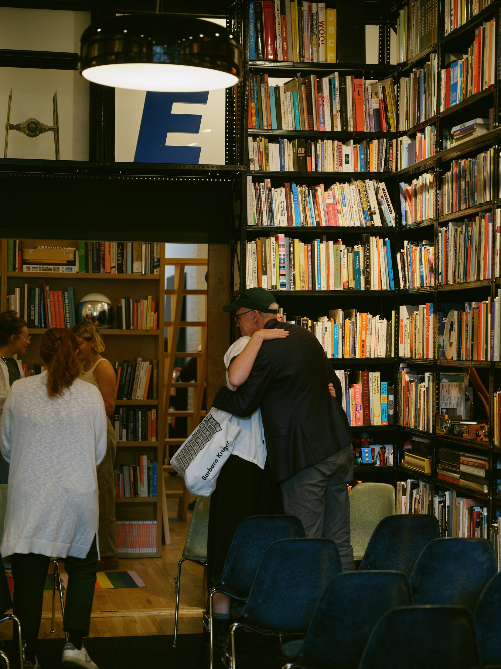 Guests embracing in the library after the conversation