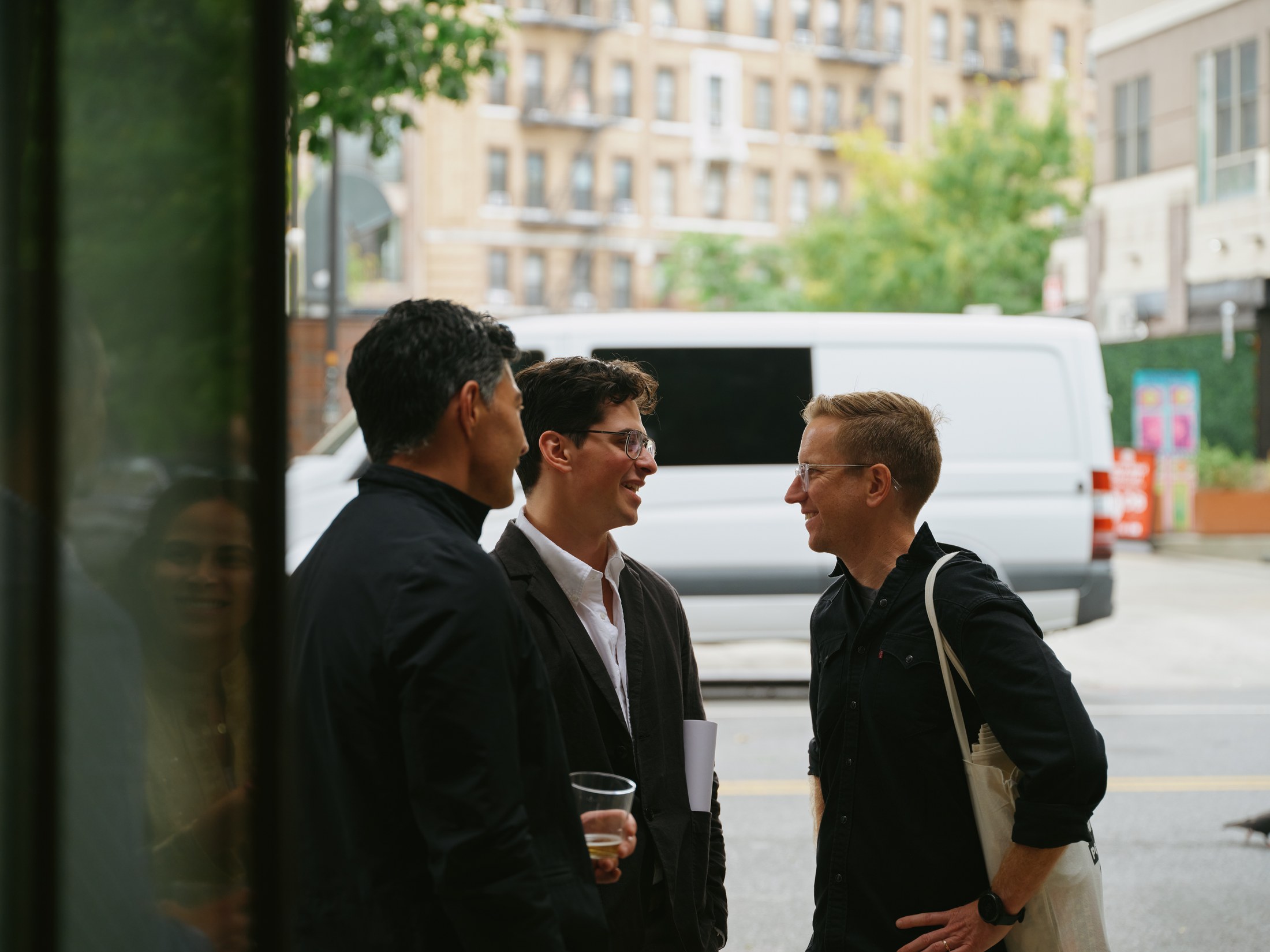 Guests continuing their conversation by the open doorway