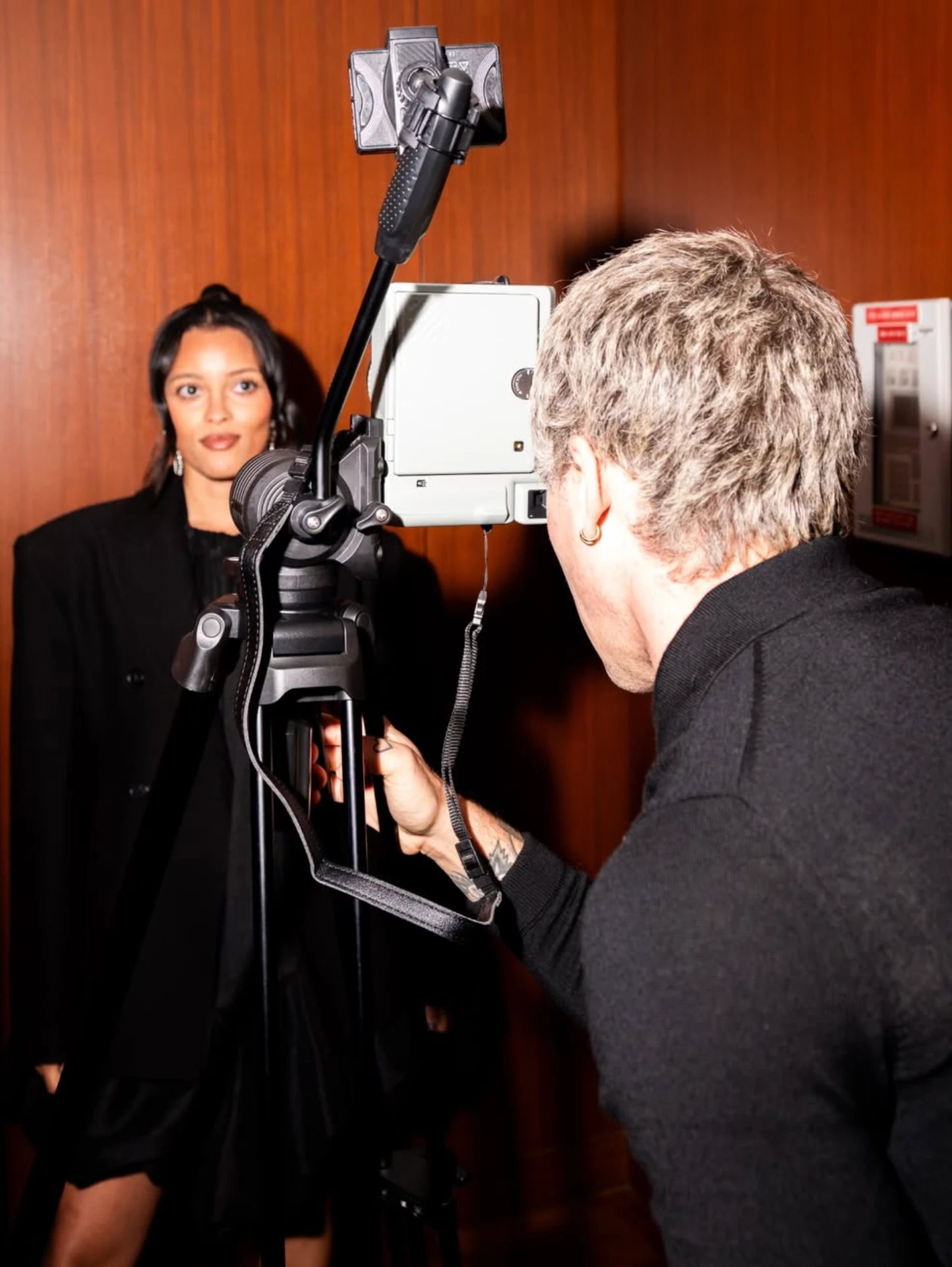 A guest having their portrait taken on an instant camera