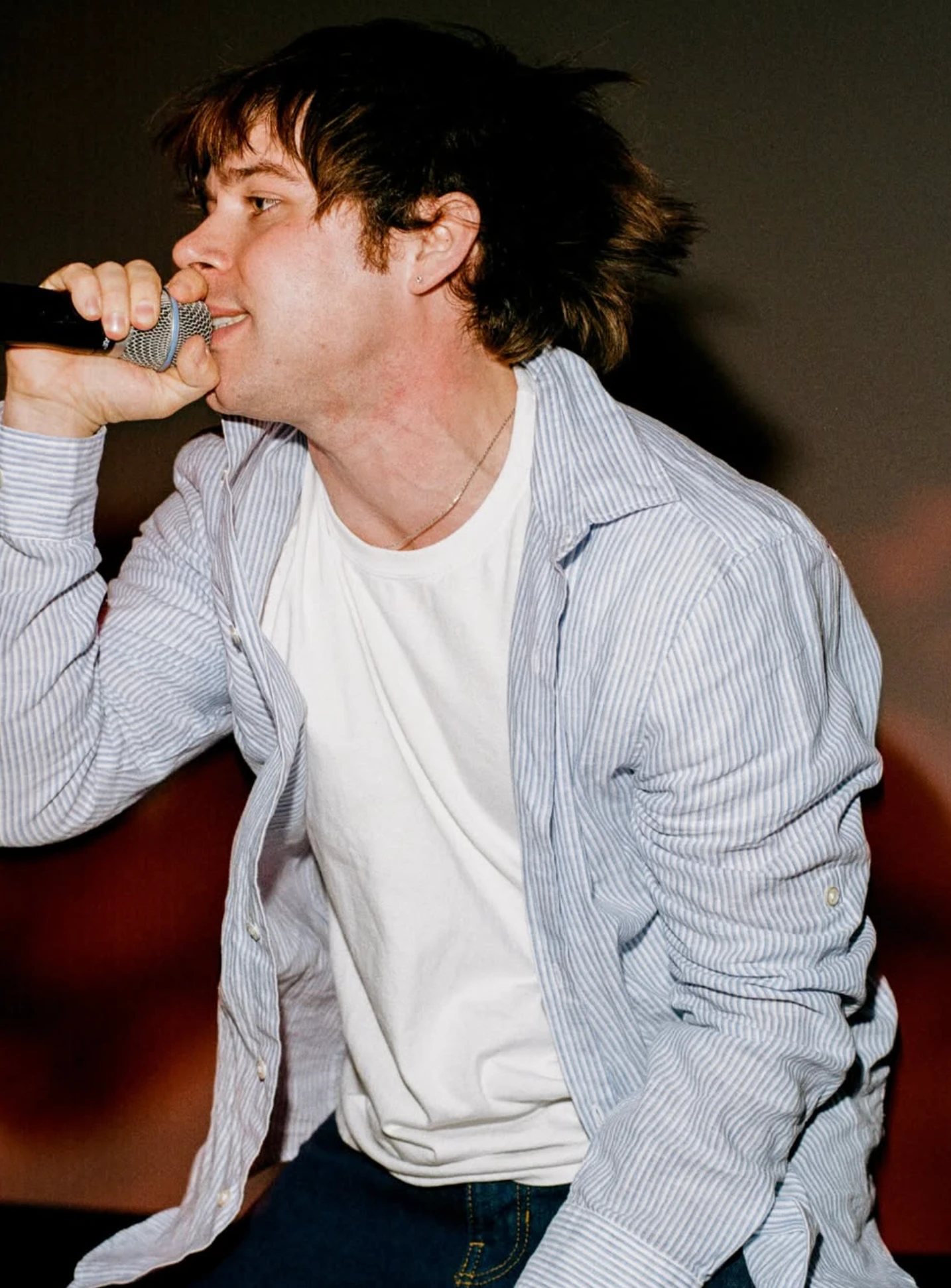 A highlight singing into a microphone